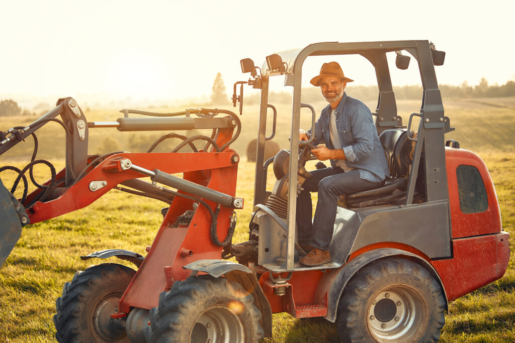Ein Mann sitzt auf seinem Traktor.